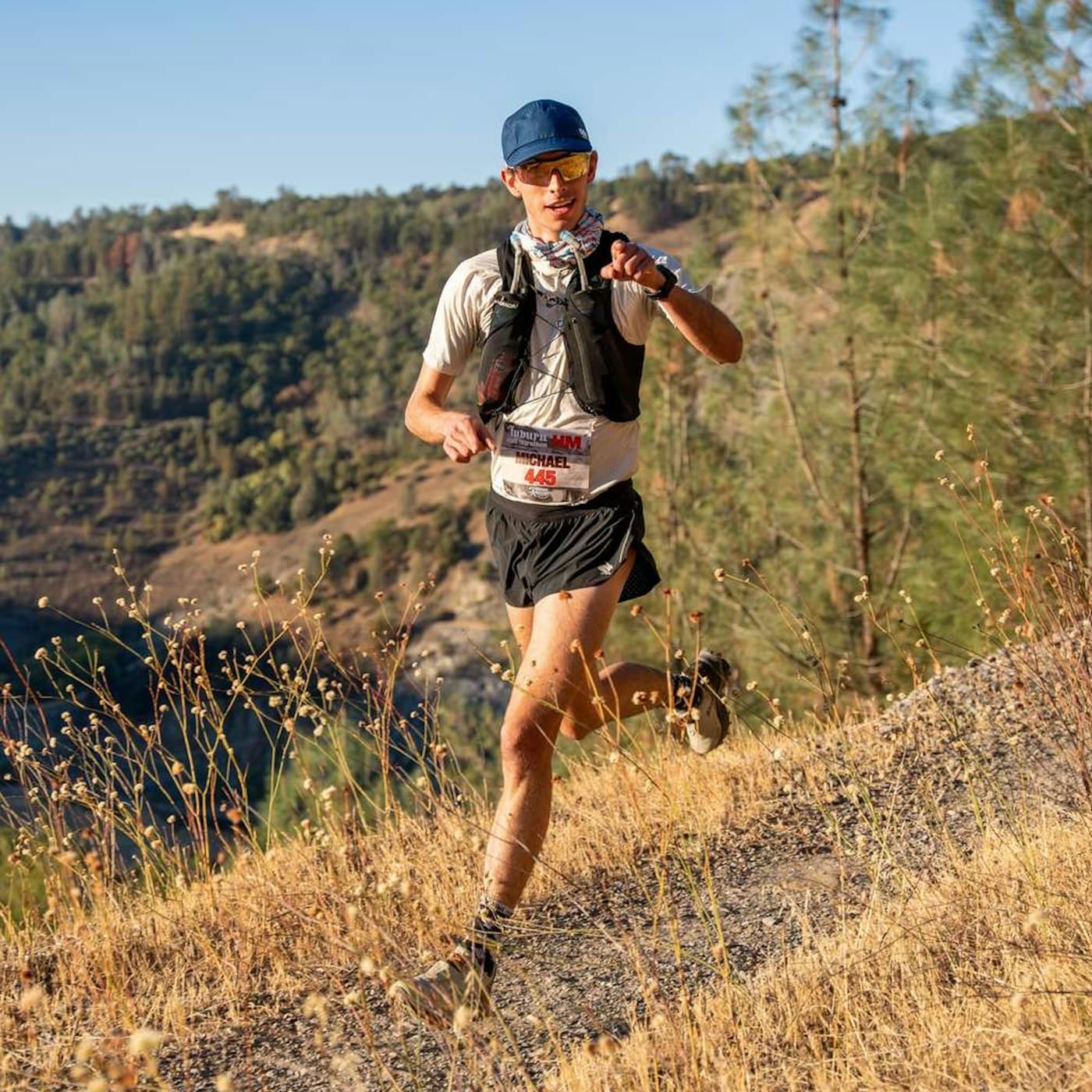 Coach running a mountain trail